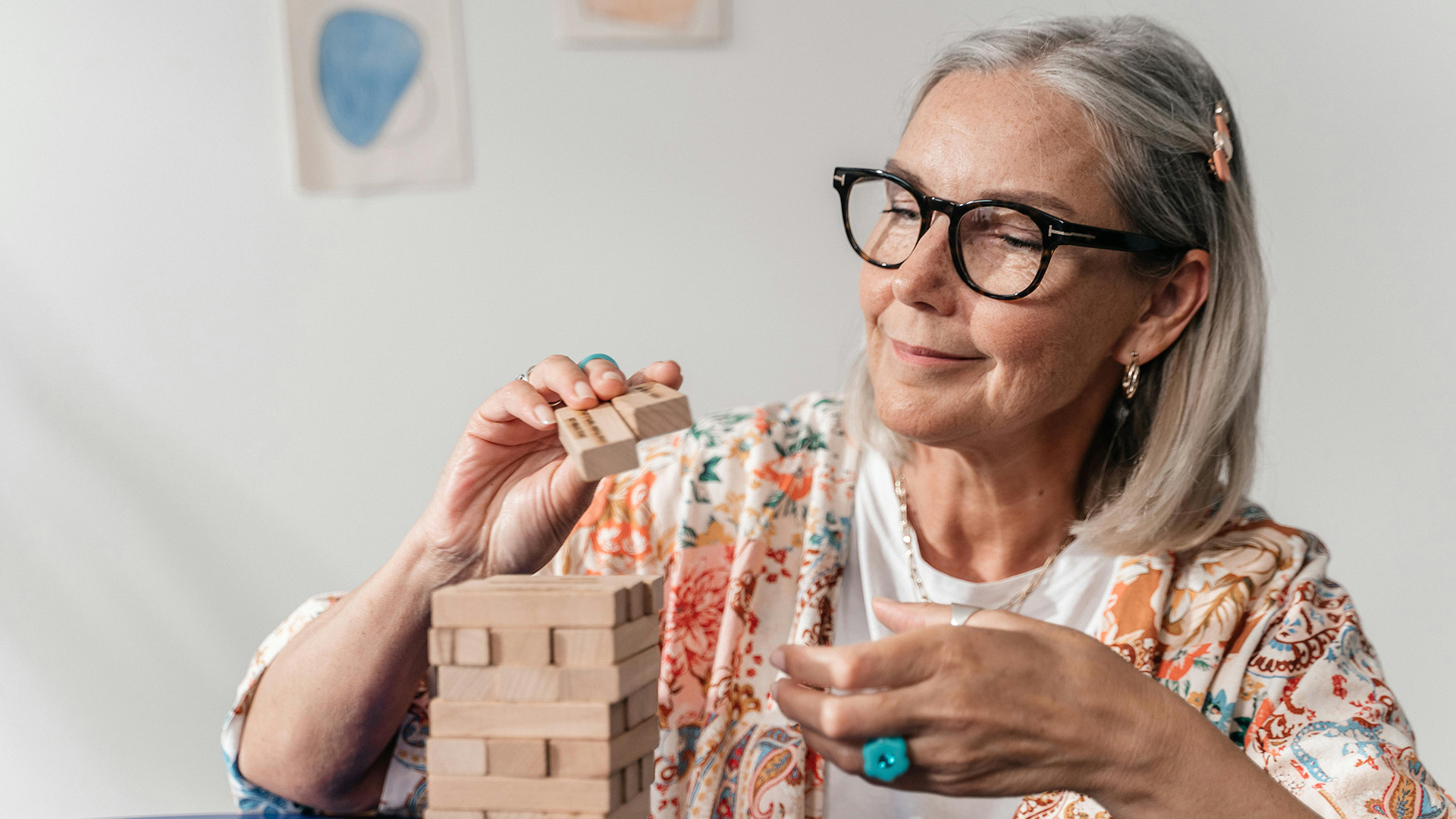 008255_LC_TherapeuticRecreationCC-Blog Older woman setting up a wooden block game